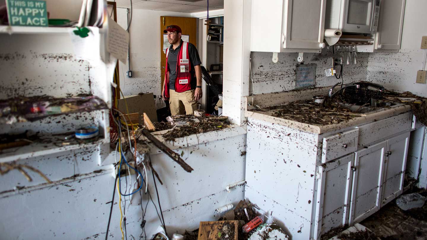 An American Red Cross aid worker surveys Hurricane Irma damage in Big Pine Key, Florida. Photo by Marko Kokic for The American Red Cross