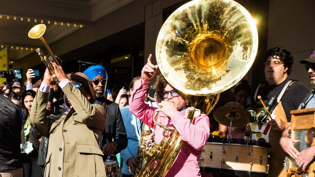 After the afternoon screening of A Tuba to Cuba, the Preservation Hall Jazz Band led a second line parade from the Paramount Theatre to the Mohawk. Photo by Jordan Hefler