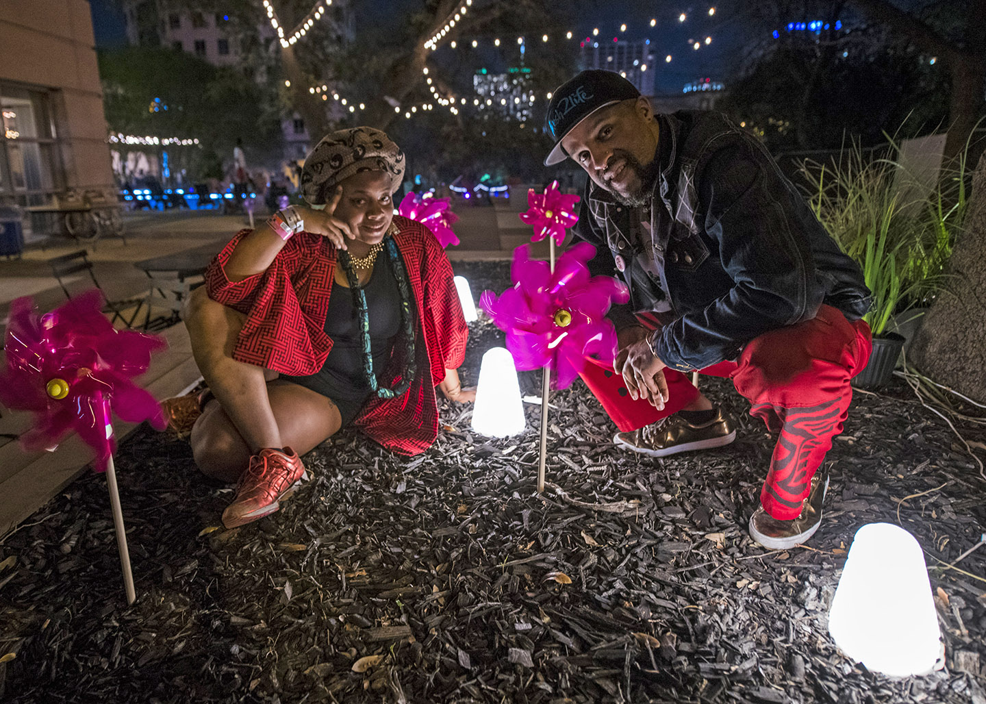 Riders Against the Storm pose for a portrait at the Artist Village after dark. Photo by David Brendan Hall