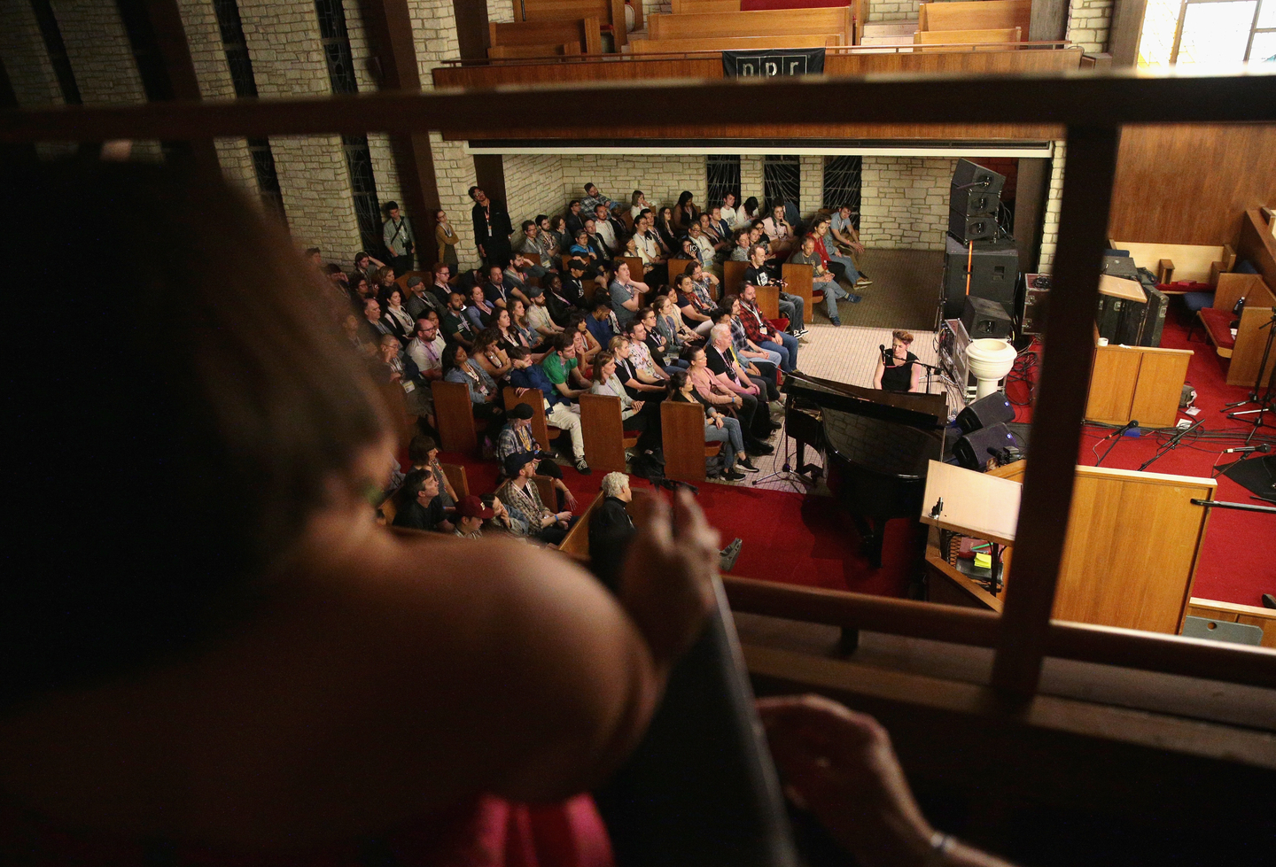 Gaelynn Lea watches Amanda Palmer perform at the NPR Tiny Desk Family Hour at Central Presbyterian Church – Photo by Steve Rogers Photography/Getty Images for SXSW