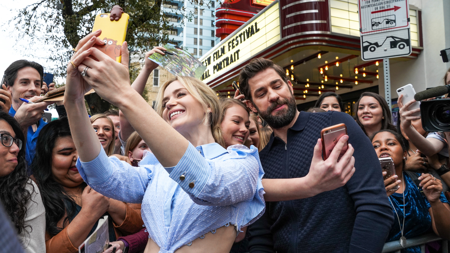 Emily Blunt and John Krasinski take selfies with fans at the premiere of “A Quiet Place” at SXSW 2018. Photo by Amy Price/Getty Images for SXSW.