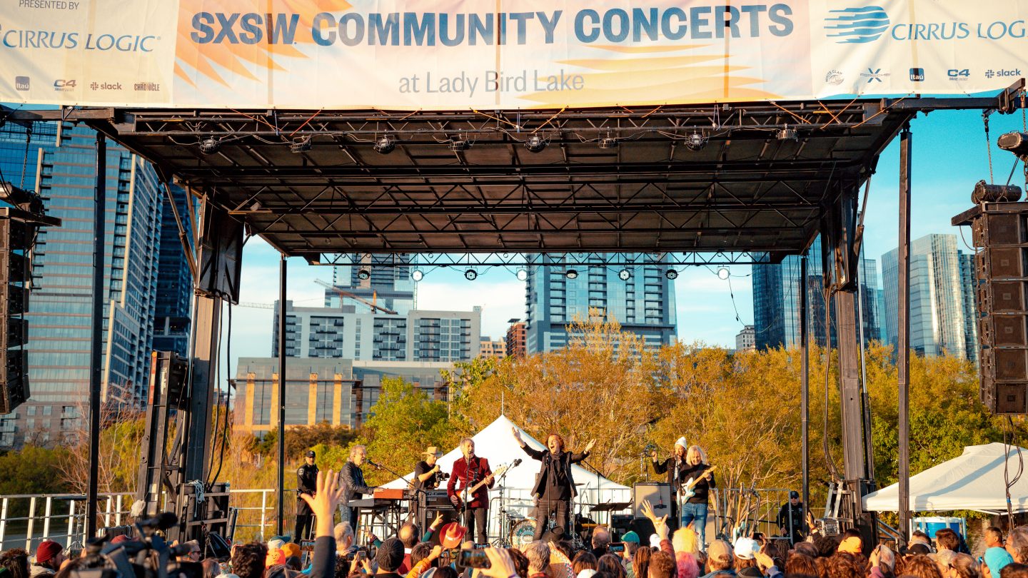 Excited concert crowd enjoying music at a live event in 2023
